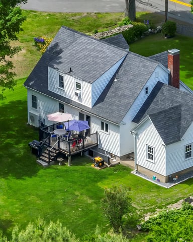 Aerial view of white Cape Neddick vacation rental with large lawn