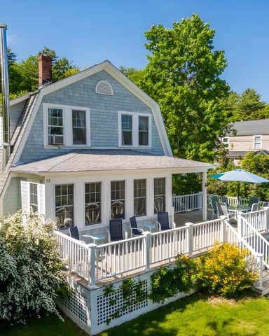 Blue shingle cottage with wrap-around porch in Ogunquit, Maine